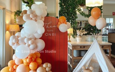 A Cozy Balloon Installation with Warm Orange Tones and Playful Lounge Styling