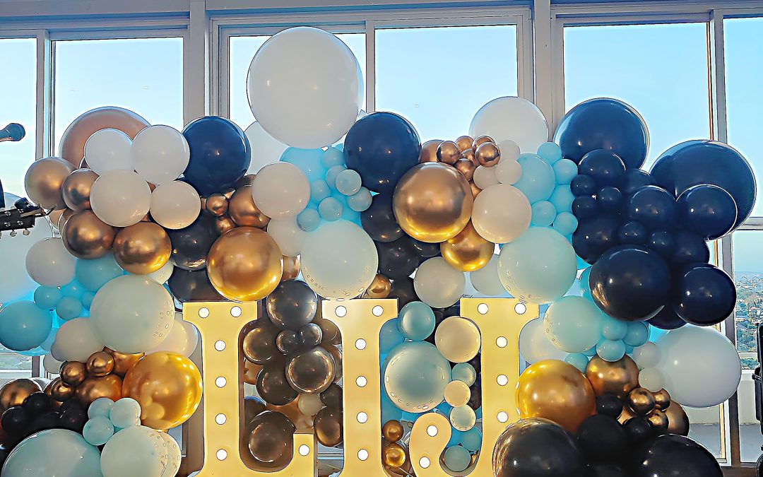 Blue and Gold Balloon Backdrop with Illuminated Letter Display