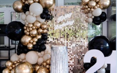 A Sophisticated Black and Gold Balloon Backdrop with Sequin Wall Styling