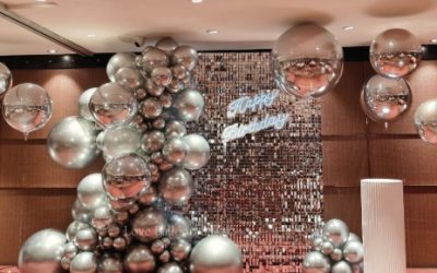 A Glamorous Metallic Balloon Installation with Sequin Backdrop Styling