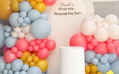 A Colorful Balloon Backdrop with Sun-Inspired Decor