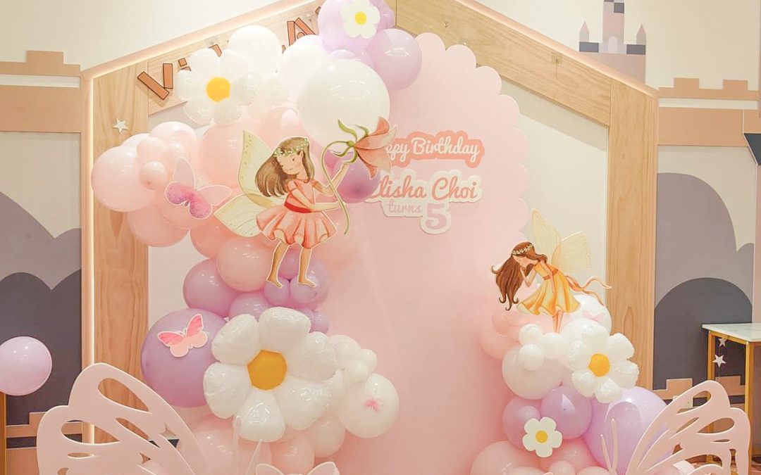 A Fairy Garden Balloon Backdrop with Pastel Balloon Celebration Styling