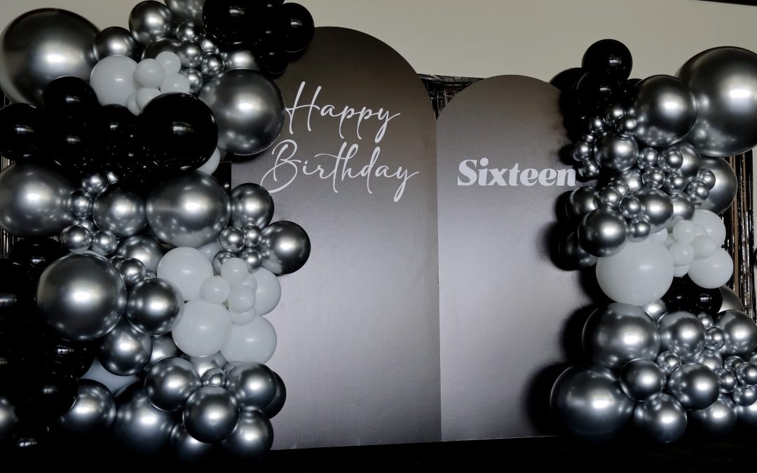 Black and Silver Balloon Installation with Modern Arch Backdrop Panels